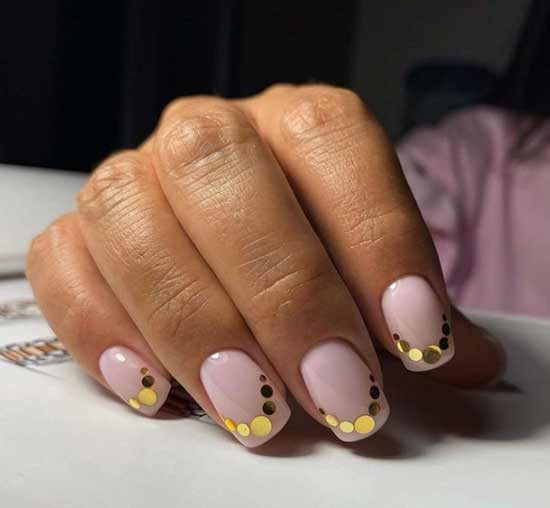Large gold sequins on the tips of the nails