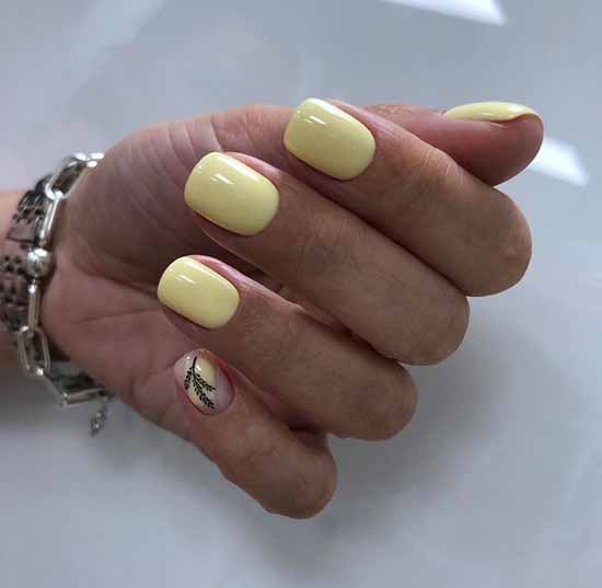 Yellow manicure with a twig