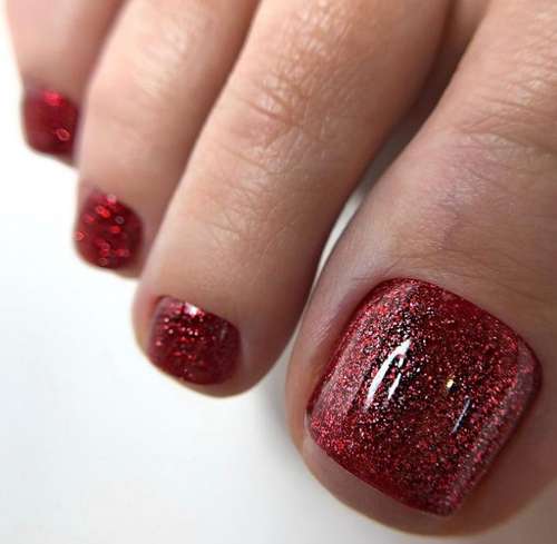 Red pedicure with glitter